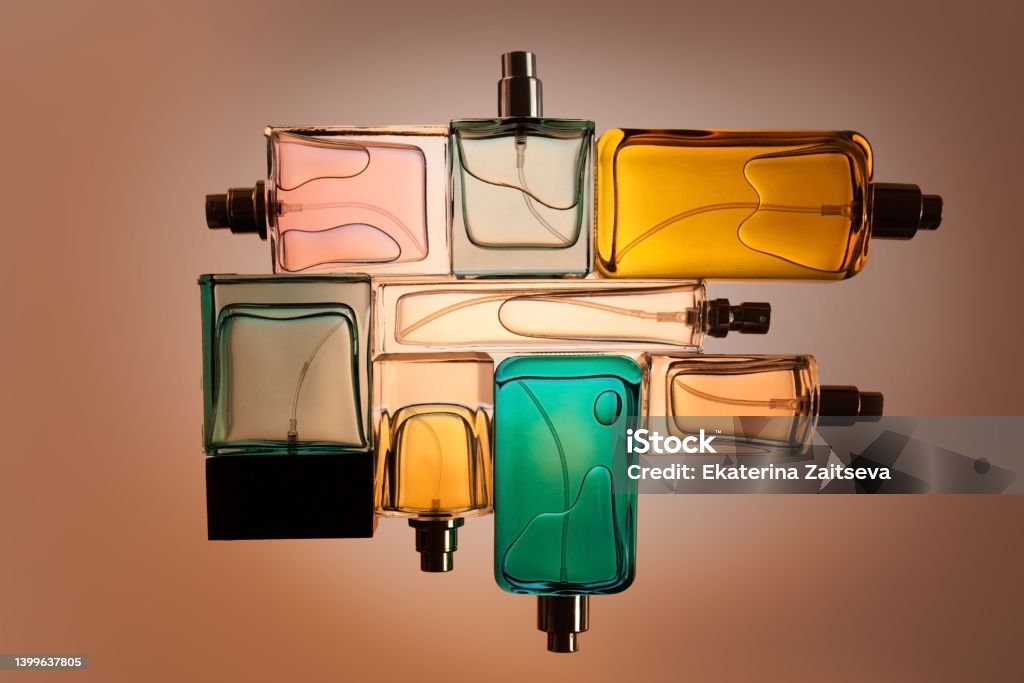 top view, flat lay of a set of perfume bottles on a beige blank background